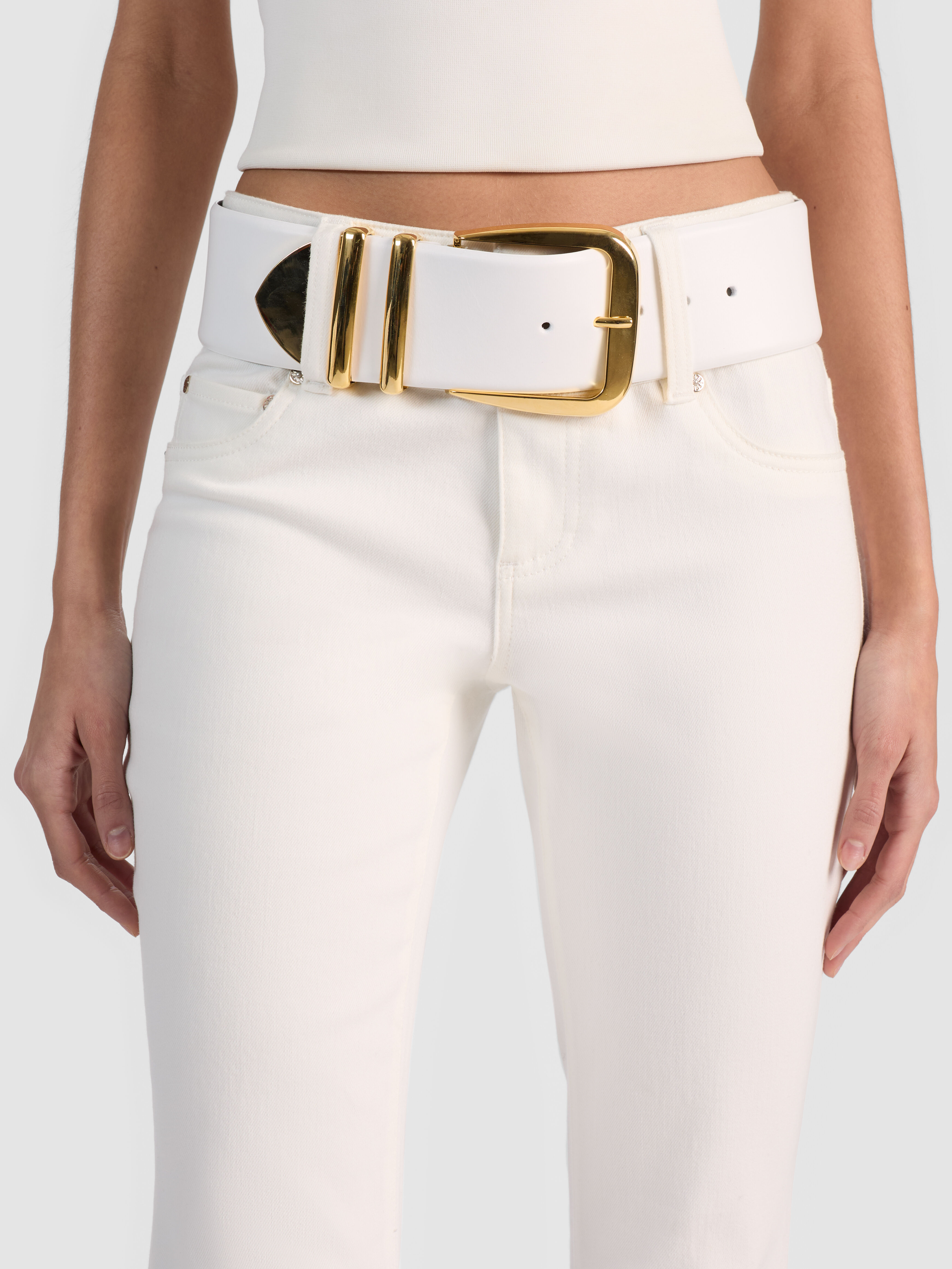 The ALICE + OLIVIA HARLEY WIDE BELT in supple Italian leather with polished gold hardware, styled over a midi dress to define the waist and add instant structure and shine.