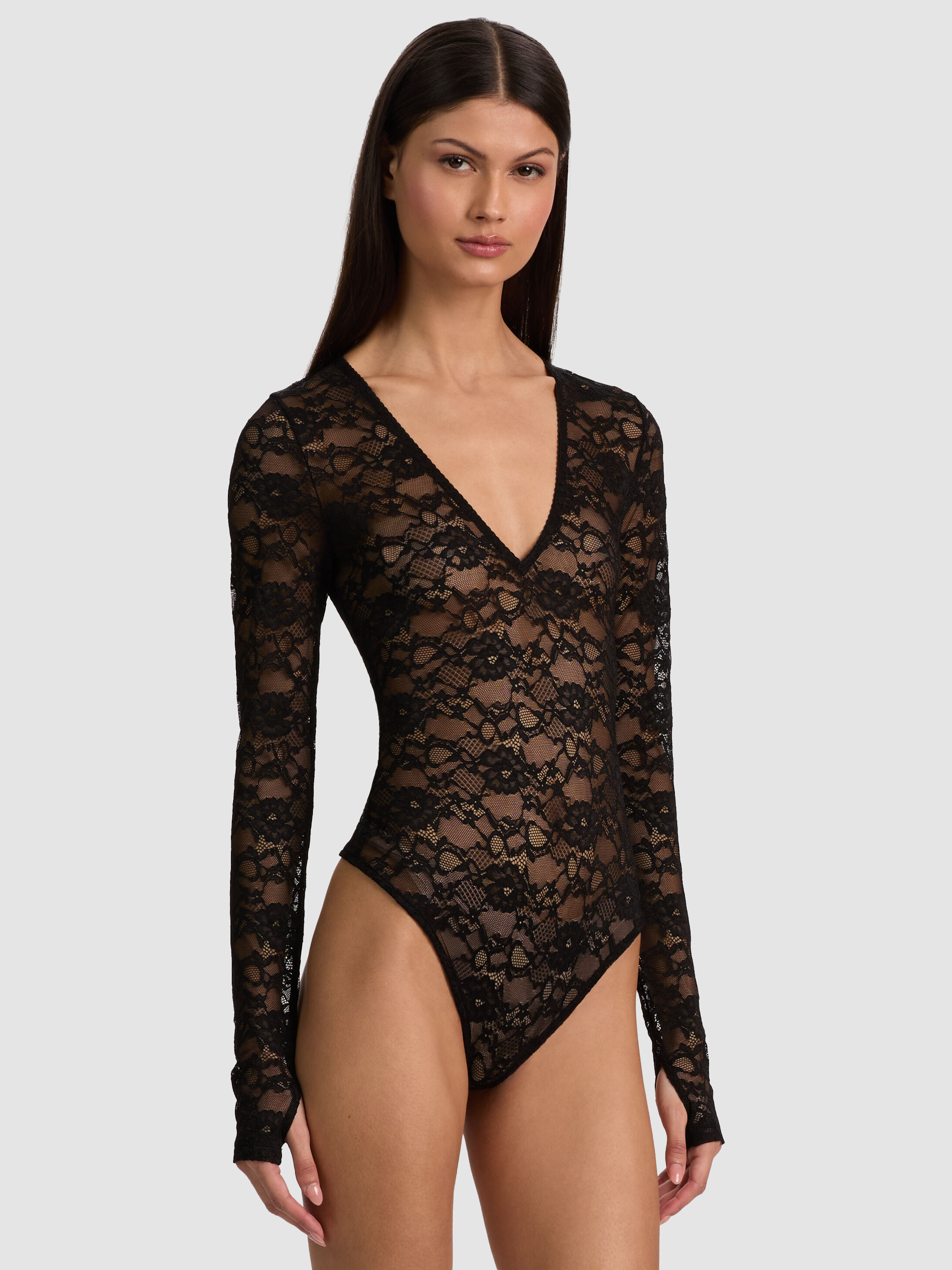 ALICE + OLIVIA Teagan Lace Bodysuit in Black — sheer lace bodysuit with plunging V-neck and long sleeves