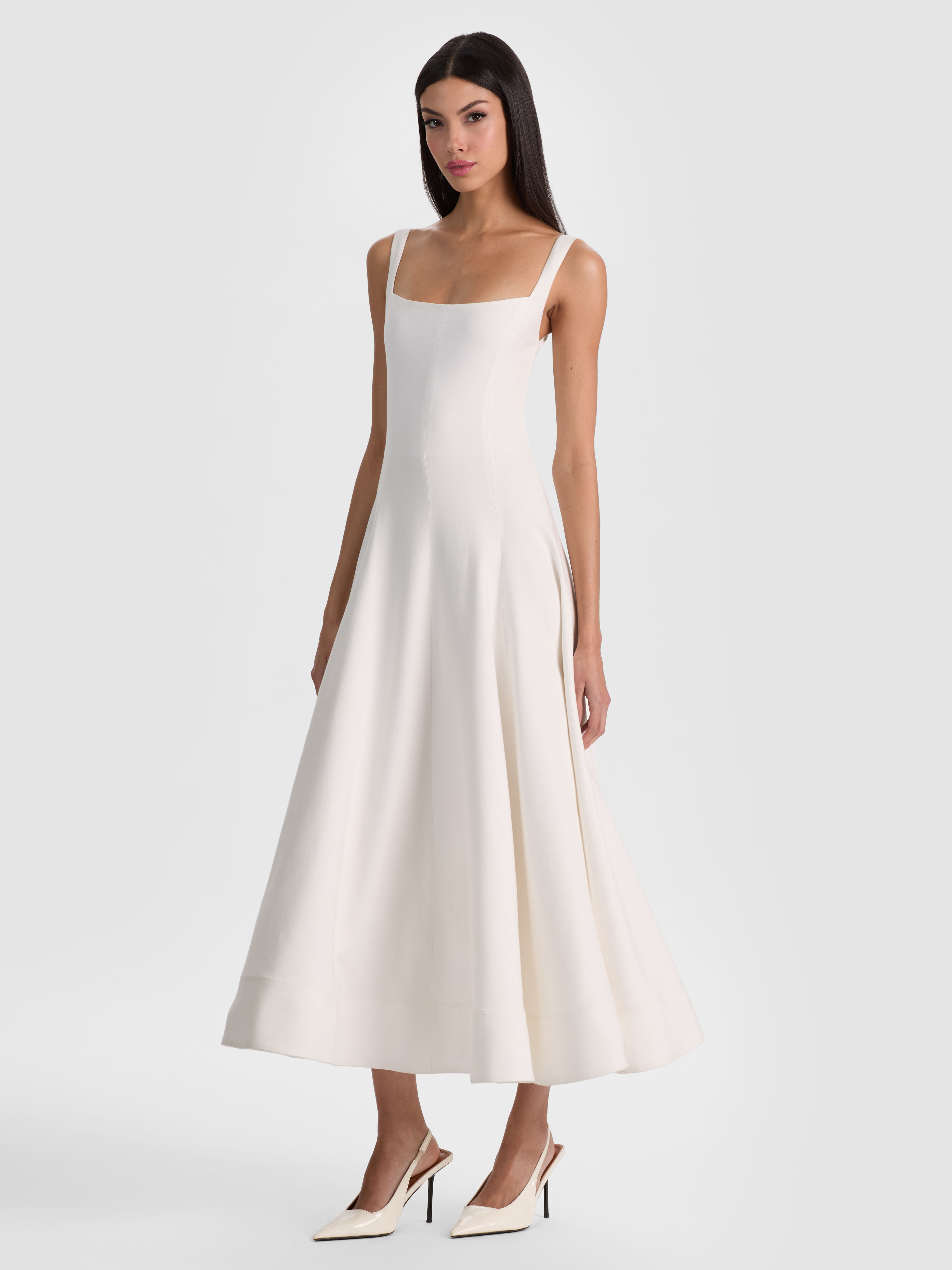 A model wearing a classic A-line dress, fitted at the bodice and gently flaring from the waist in a soft feminine silhouette